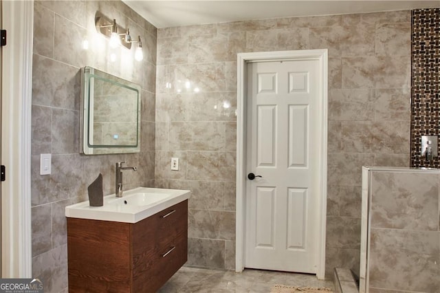 bathroom with vanity and tile walls