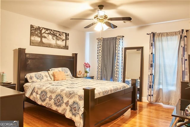 bedroom with ceiling fan and light hardwood / wood-style floors