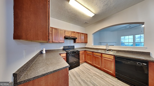 kitchen featuring black appliances, sink, ceiling fan, a textured ceiling, and light hardwood / wood-style floors