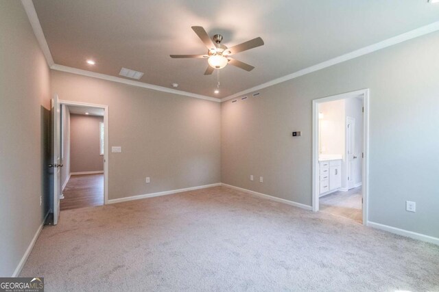 empty room with light colored carpet, ceiling fan, and ornamental molding