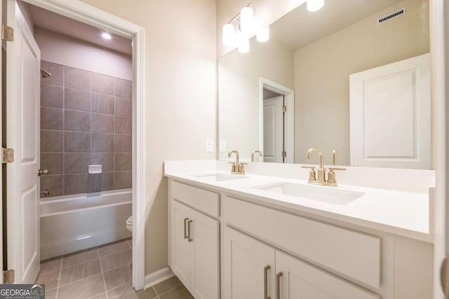 full bathroom with tile patterned floors, toilet, vanity, and tiled shower / bath