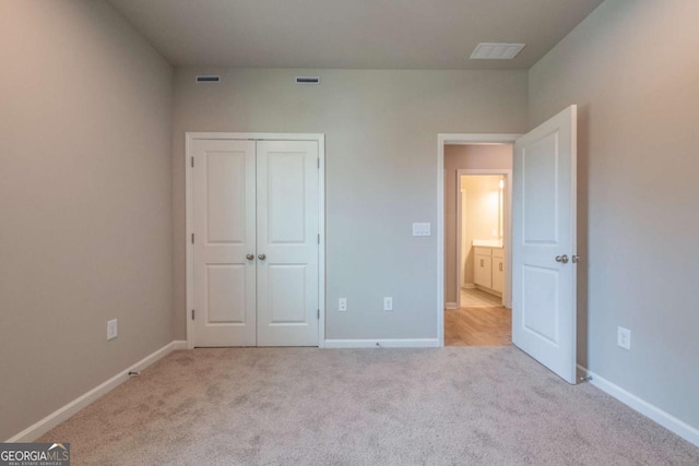 unfurnished bedroom with light colored carpet