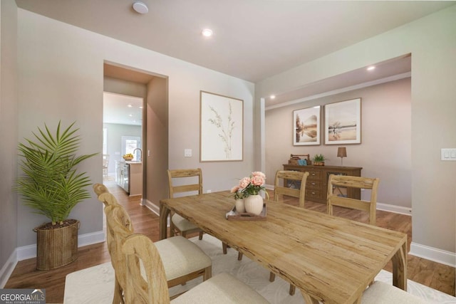 dining space with wood-type flooring