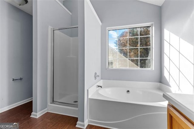 bathroom featuring separate shower and tub, vanity, and hardwood / wood-style flooring