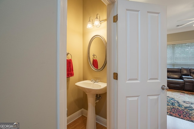 bathroom with hardwood / wood-style flooring, ceiling fan, and crown molding