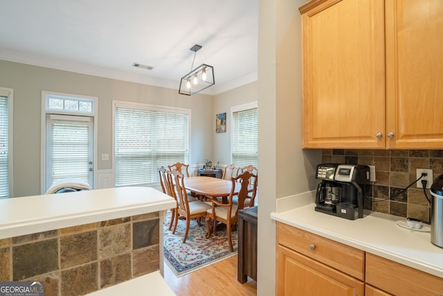 dining area featuring light hardwood / wood-style floors and ornamental molding