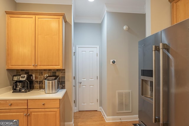 kitchen with backsplash, high end refrigerator, light hardwood / wood-style flooring, and ornamental molding