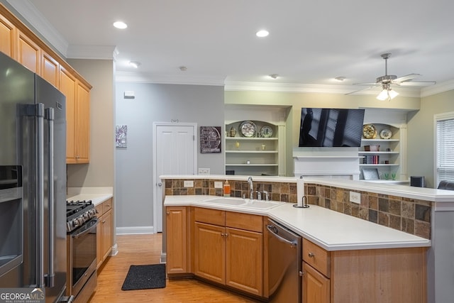 kitchen featuring appliances with stainless steel finishes, ceiling fan, sink, built in features, and a kitchen island