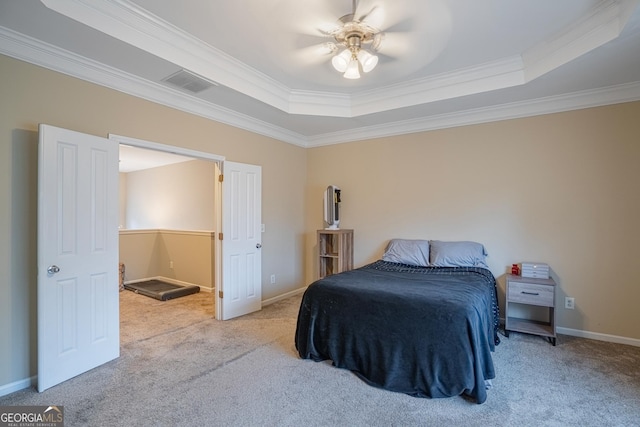 bedroom with a raised ceiling, ceiling fan, light carpet, and ornamental molding