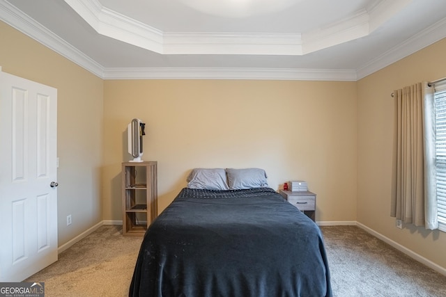 carpeted bedroom featuring a tray ceiling and crown molding