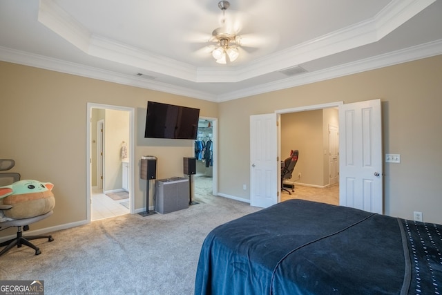 bedroom featuring a raised ceiling, ceiling fan, and ornamental molding