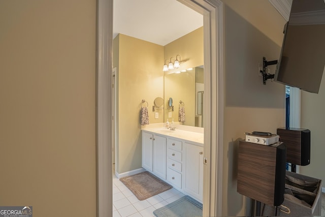 bathroom featuring tile patterned flooring, vanity, and crown molding