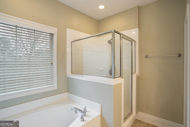 bathroom featuring tile patterned flooring and independent shower and bath