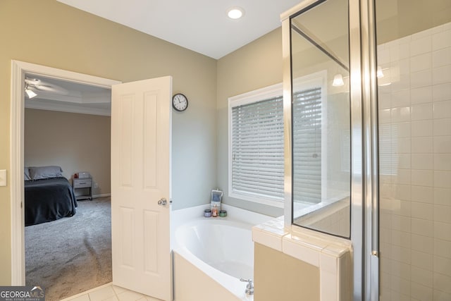 bathroom featuring shower with separate bathtub, tile patterned floors, plenty of natural light, and ornamental molding