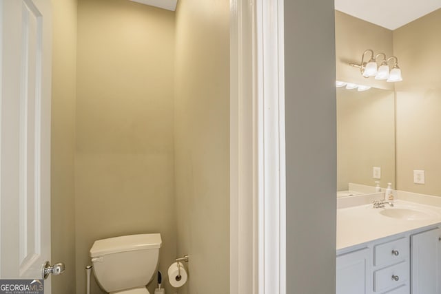 bathroom featuring vanity and toilet