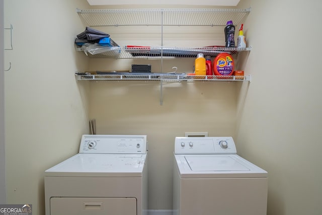 clothes washing area featuring separate washer and dryer