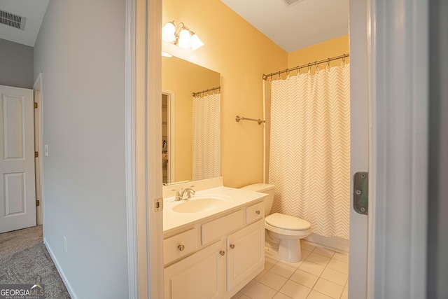 bathroom with tile patterned floors, curtained shower, vanity, and toilet