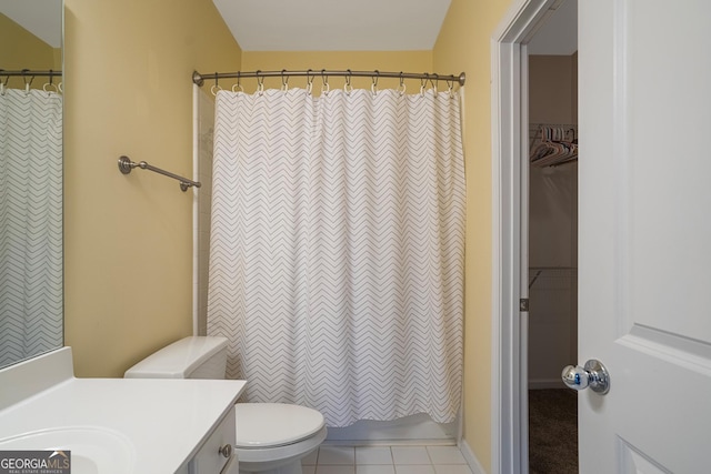 bathroom with tile patterned flooring, vanity, and toilet