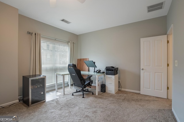 office featuring ceiling fan and light colored carpet