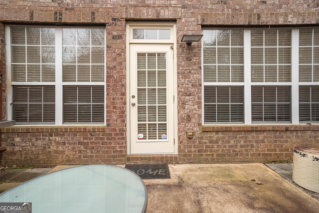 entrance to property with a patio