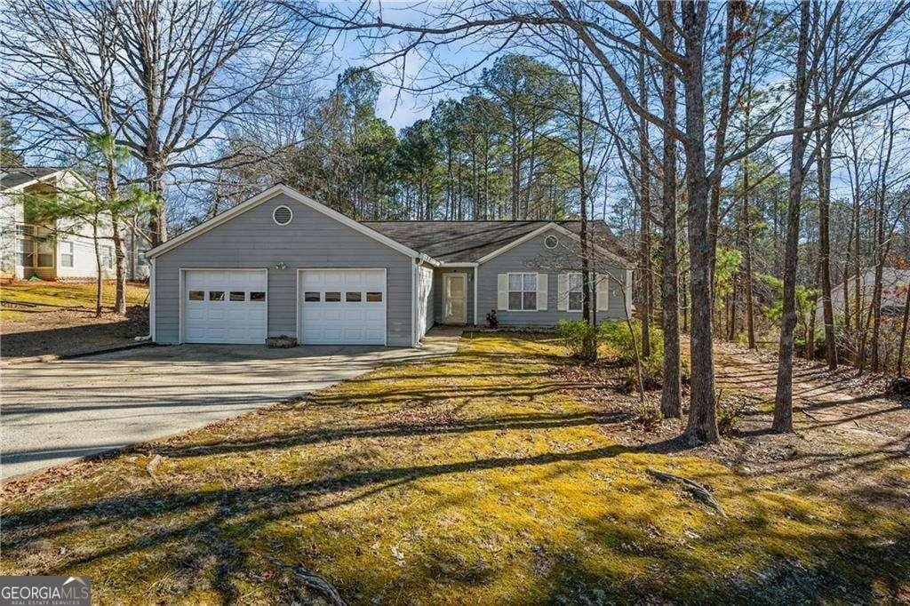 view of front facade with concrete driveway and a garage