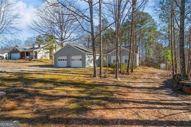 view of front facade with a garage and a front lawn