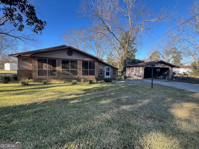 view of front of house with a front yard, a garage, and an outdoor structure