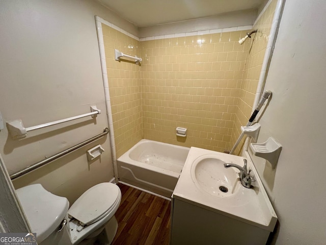 full bathroom with toilet, vanity, tiled shower / bath combo, and hardwood / wood-style flooring