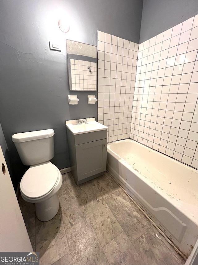 bathroom with vanity, toilet, and a bathing tub