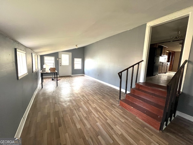 interior space with wood-type flooring and vaulted ceiling