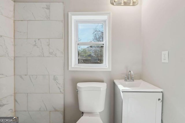 bathroom featuring vanity and toilet