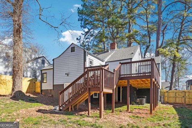 back of property with central AC and a wooden deck