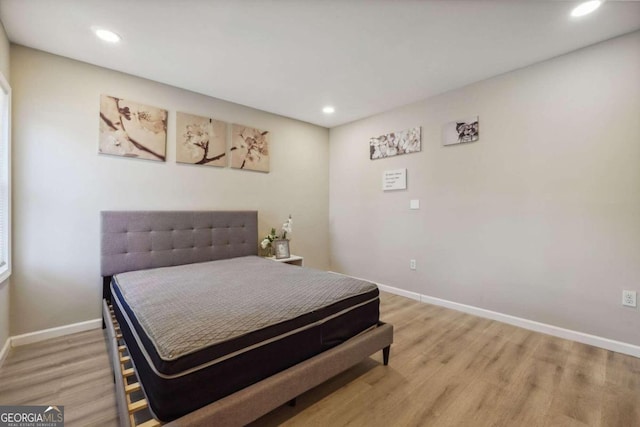 bedroom with hardwood / wood-style flooring