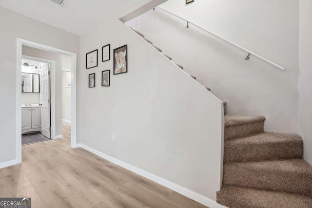 stairway with hardwood / wood-style floors