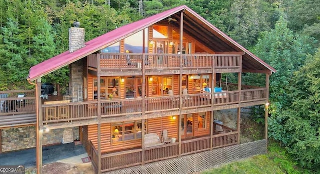 rear view of house with a patio area and a wooden deck