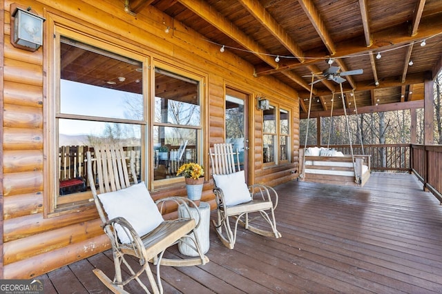 wooden terrace with ceiling fan and covered porch