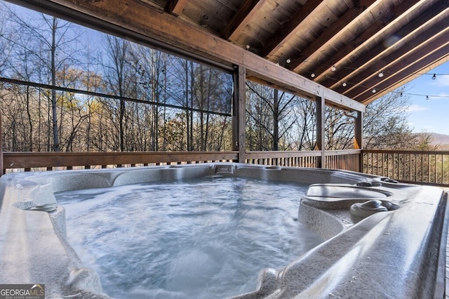 wooden deck featuring a hot tub