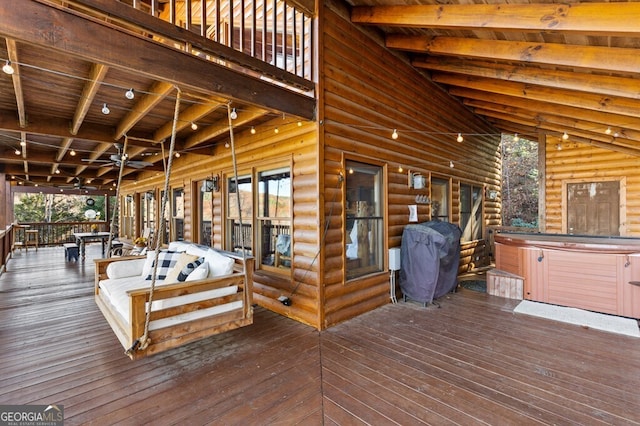 deck featuring a hot tub and a grill