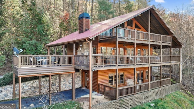 rear view of house with a deck and a patio