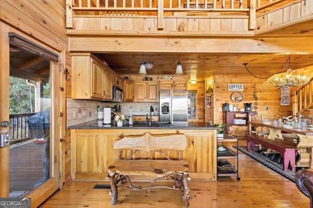 kitchen with an inviting chandelier, sink, light hardwood / wood-style flooring, decorative light fixtures, and stainless steel appliances