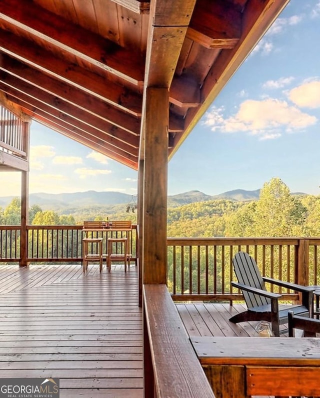 wooden deck featuring a mountain view