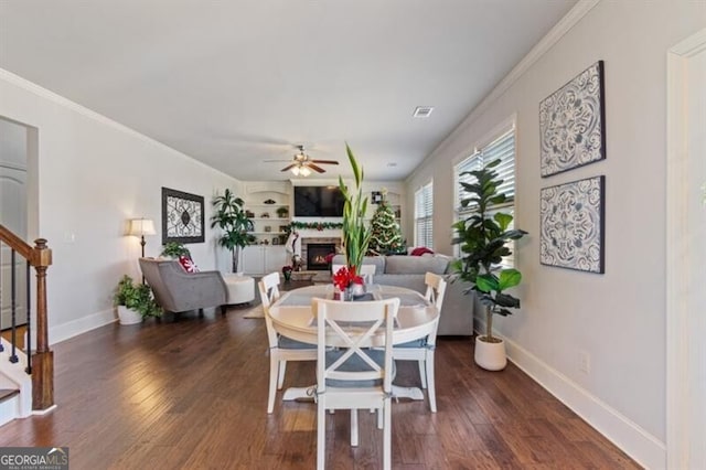 dining room featuring crown molding, dark hardwood / wood-style floors, and ceiling fan