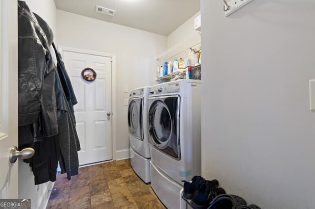 clothes washing area featuring independent washer and dryer