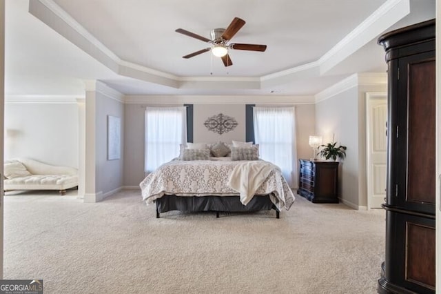 carpeted bedroom with a raised ceiling, crown molding, ceiling fan, and multiple windows