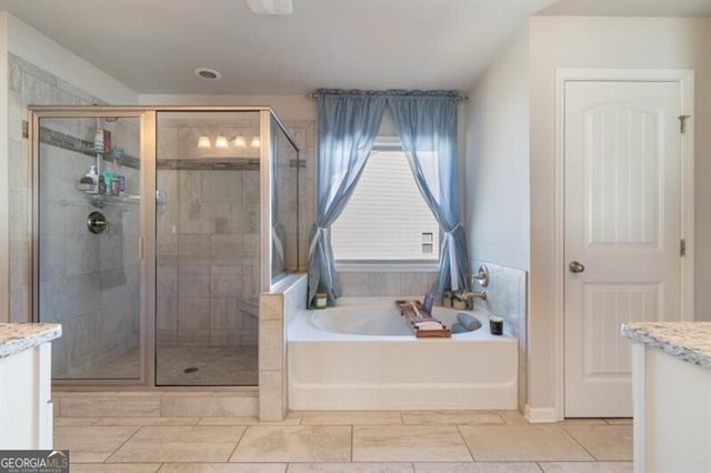 bathroom with vanity and separate shower and tub