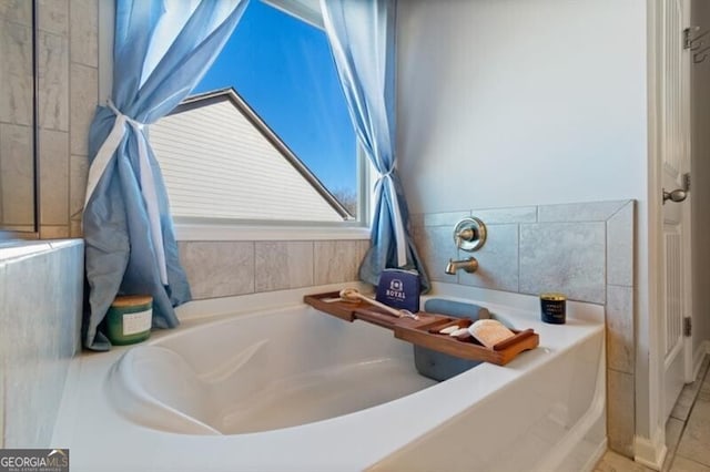 bathroom featuring tile patterned flooring and a tub to relax in