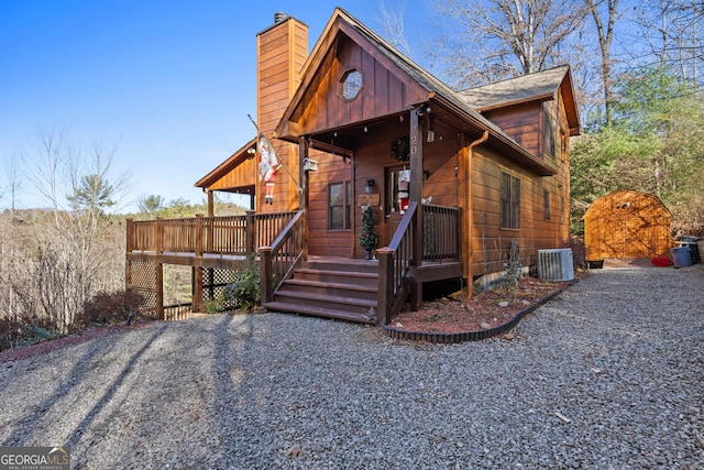 cabin featuring central air condition unit and a porch