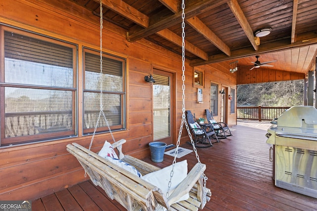 wooden deck with ceiling fan and a grill