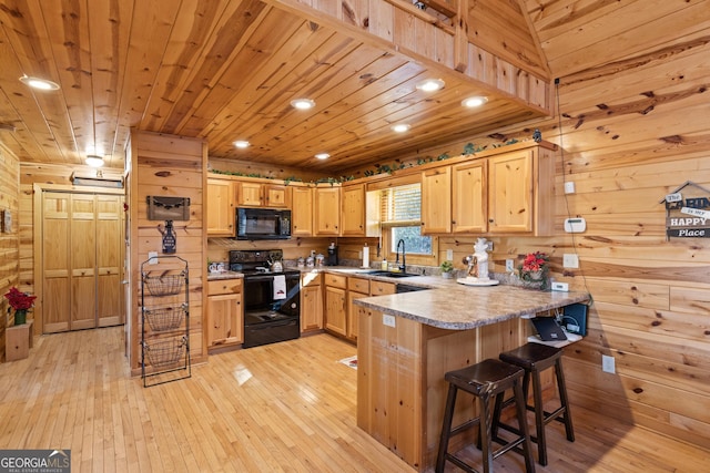 kitchen featuring a breakfast bar area, black appliances, wood ceiling, light brown cabinets, and sink