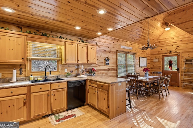 kitchen featuring kitchen peninsula, lofted ceiling, hanging light fixtures, sink, and dishwasher